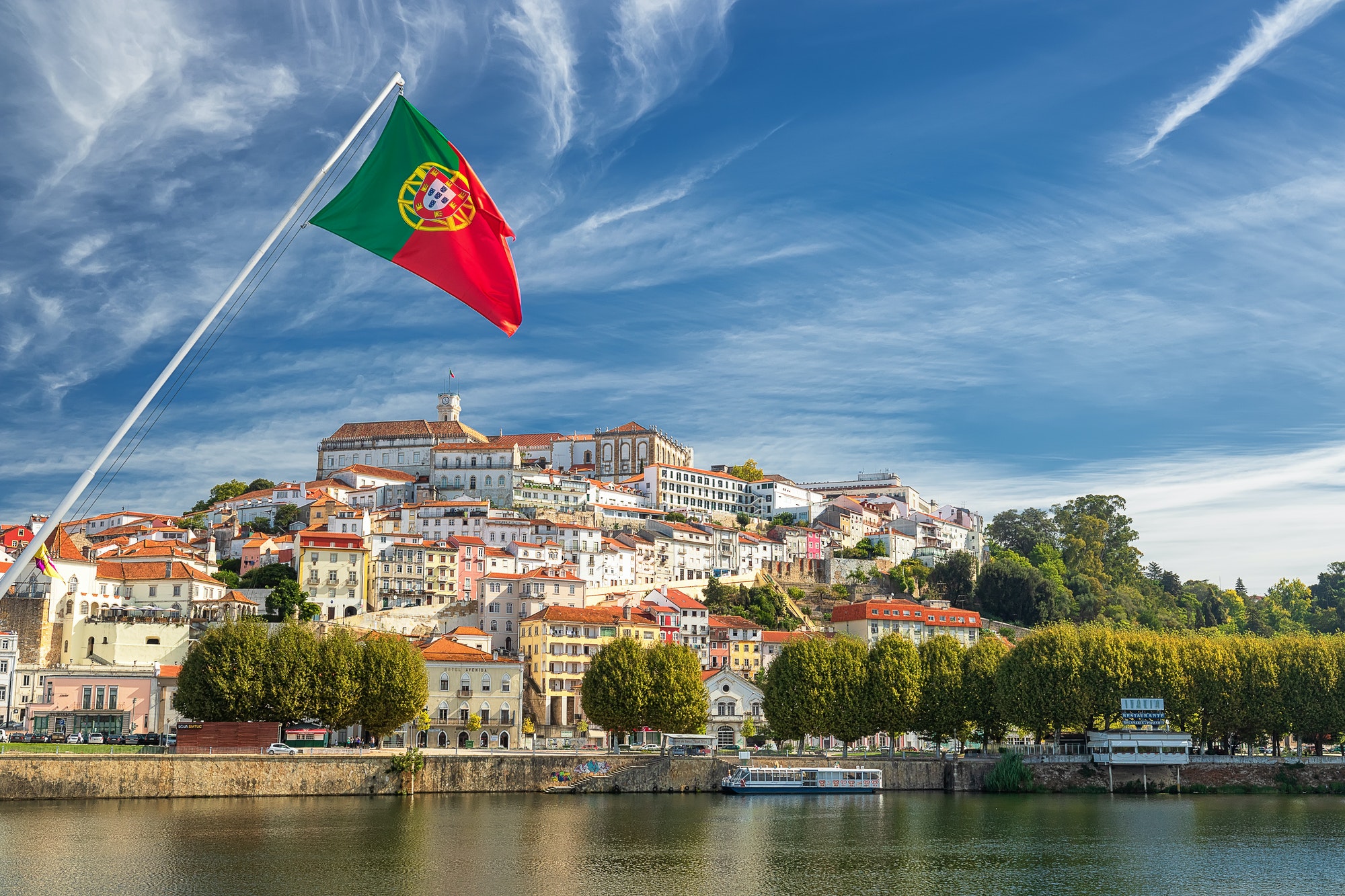 Old university city of Coimbra and the medieval capital of Portugal with Portuguese flag. Europe