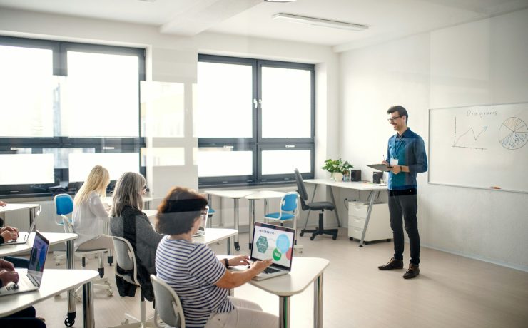 Group of senior people attending computer and technology education class