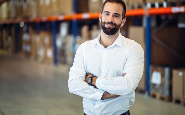 Logistics manager posing in warehouse