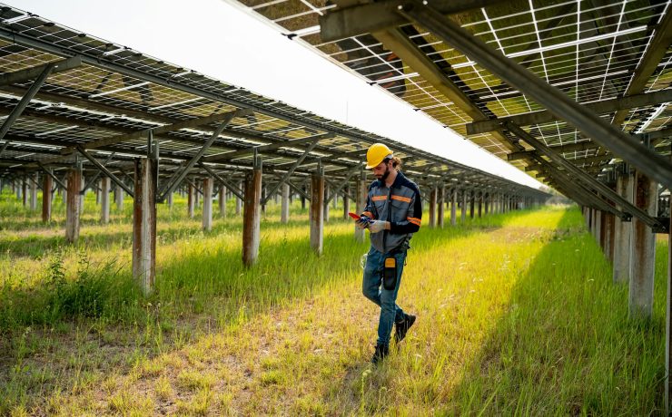 photovoltaic panel, Engineer with energy measurement tool photovoltaic modules for energy